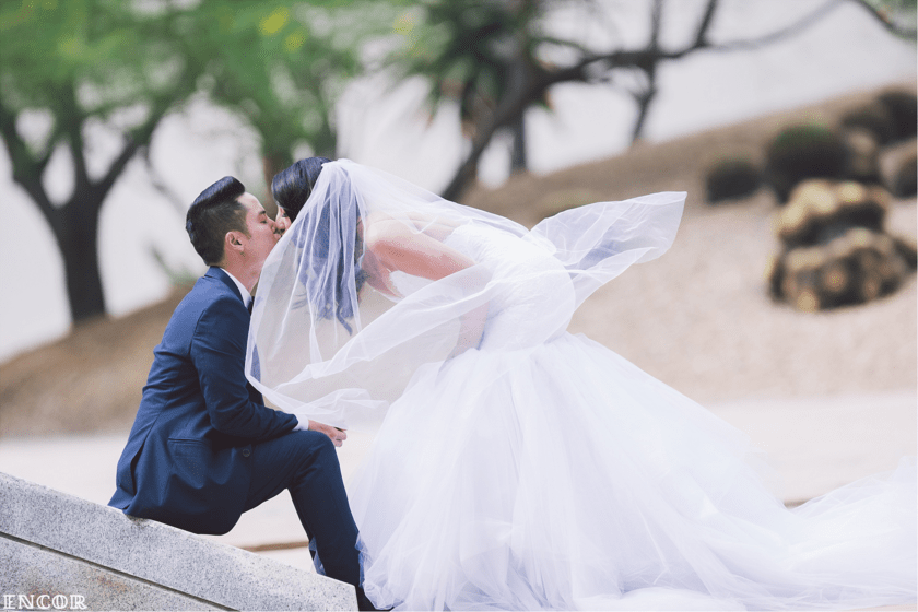 Bride Michele poses with her veil in her Lauren Elaine mermaid wedding gown
