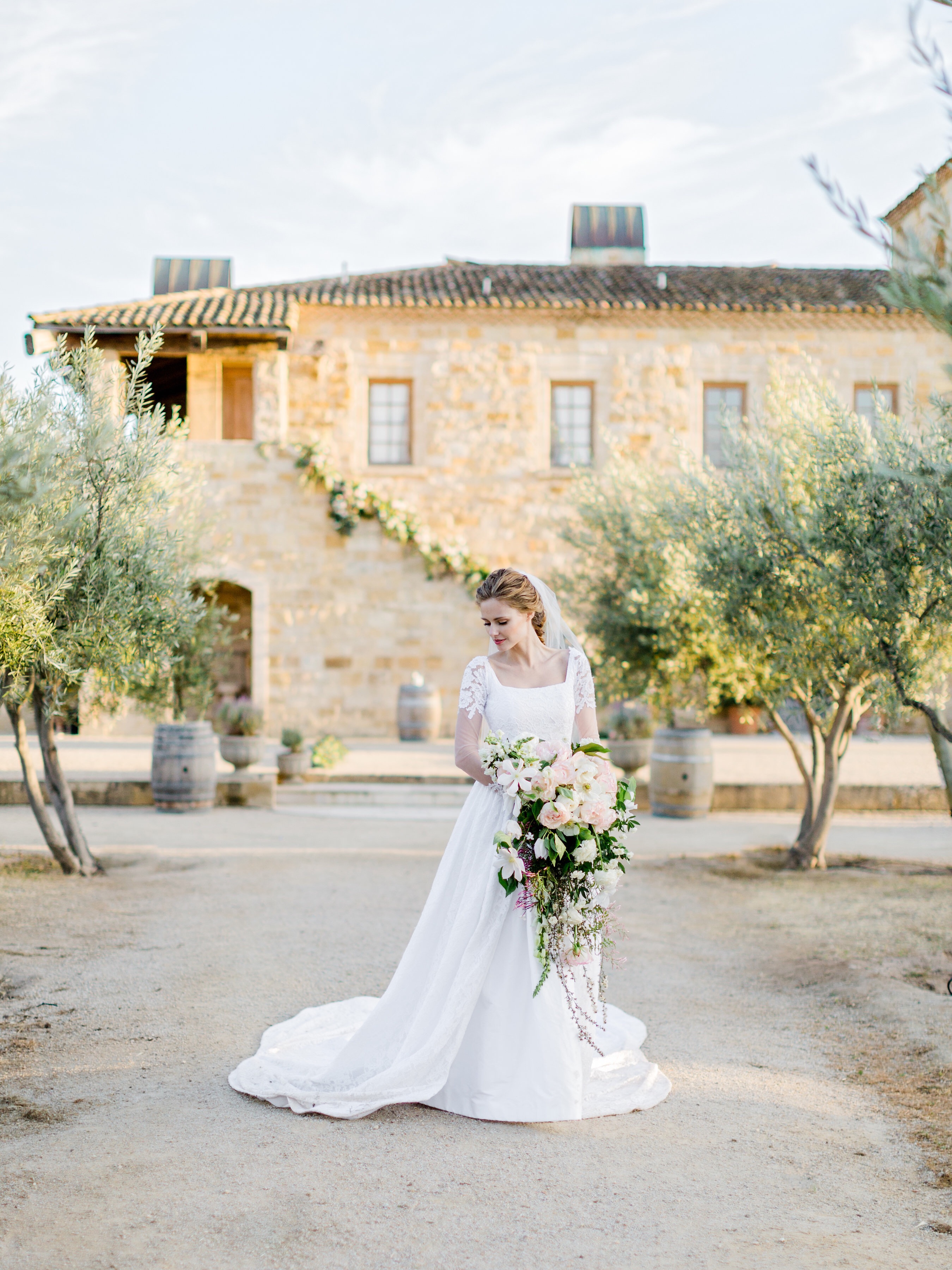 Alyssa Campanella's custom Lauren Elaine wedding gown with lace illusion sleeves and cathedral train