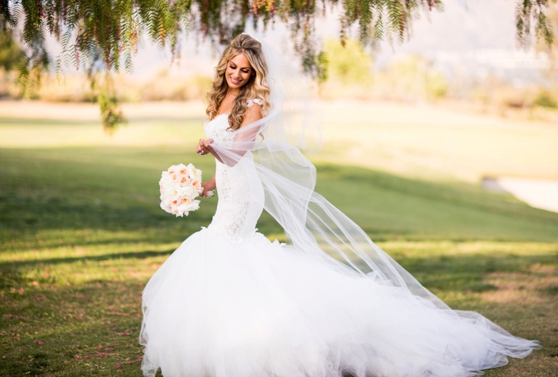 Bride Tal wears her custom Lauren Elaine mermaid wedding gown with detachable cathedral tulle train and veil with blusher.