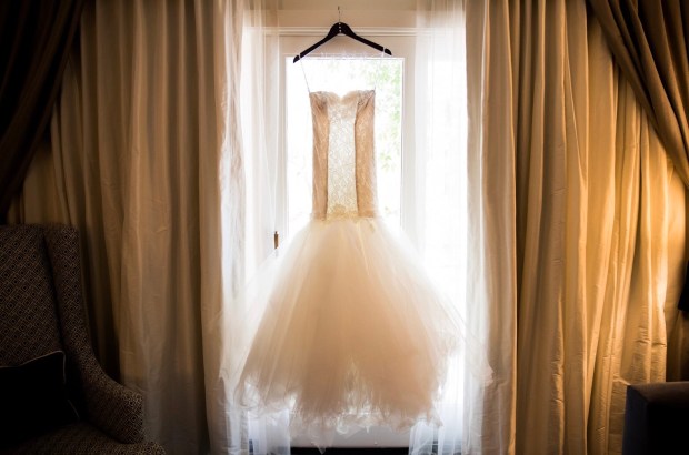 Custom Lauren Elaine Bridal mermaid wedding dress with champagne illusion side paneling and feathered tulle skirt with detachable cathedral train.