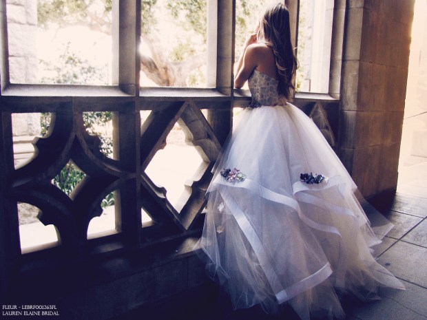 Pewter mist blue-hued ball gown wedding gown with lavender, purple, and jade mint flower details and metallic brocade bodice.