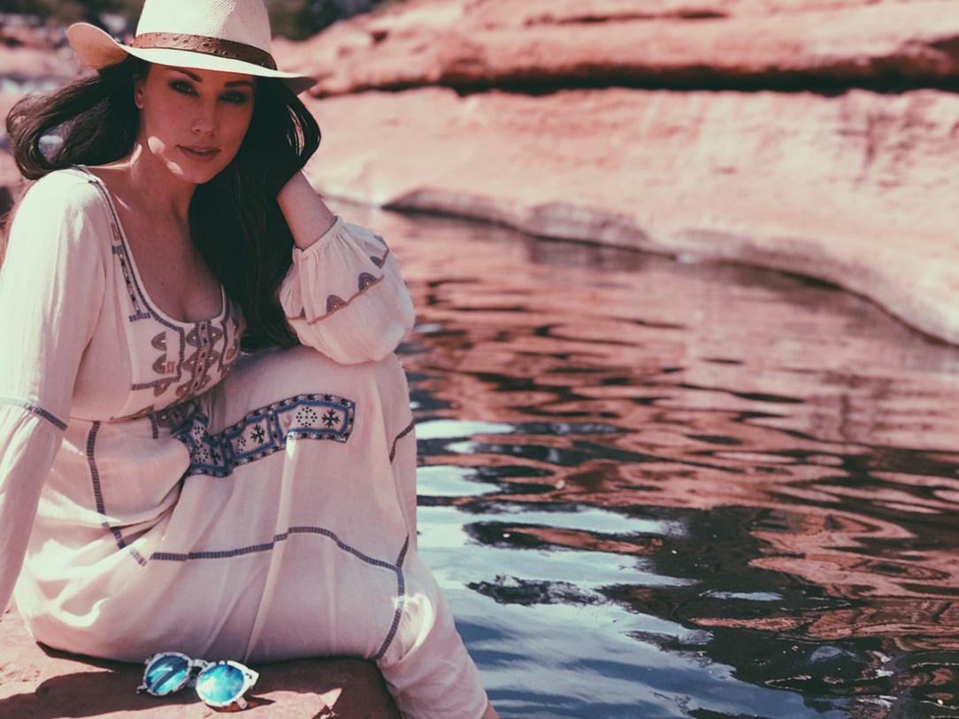 Lauren Elaine dips her toes in the water at Slide Rock State Park in Sedona, Arizona