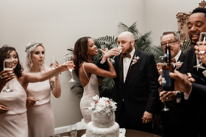 Bride Harmony drinks champagne in her Lauren Elaine Arabelle wedding dress