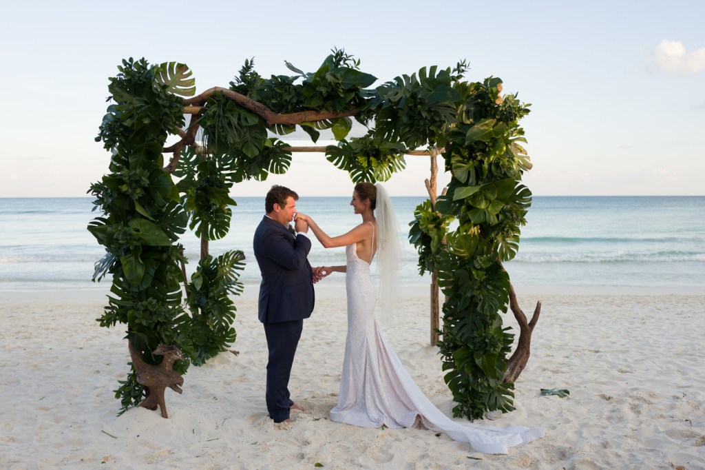Bride Geniffer embraces her husband in her Lauren Elaine "Prism" gown.