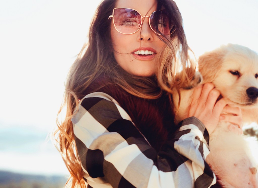 Fashion Designer Lauren Elaine plays with her golden retriever puppy, "Mojave"
