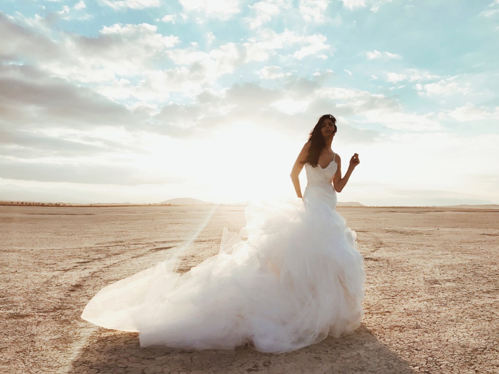 A model wears the Elysian gown by Lauren Elaine Bridal at El Mirage dry lake bed in California