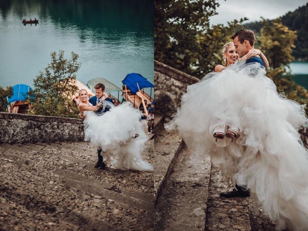 A bride follows tradition and is carried up the stairs at Lake Bled, Slovenia