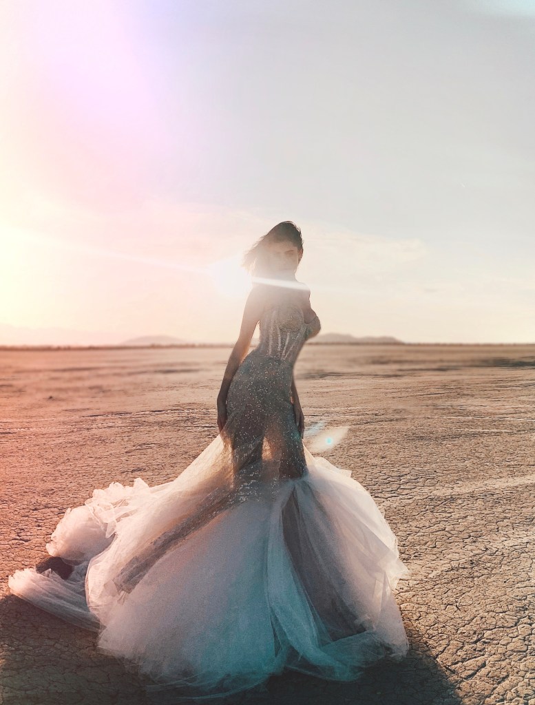 A model wears a corset beaded mermaid wedding dress inspired by Scorpio from the Lauren Elaine Stardust Collection