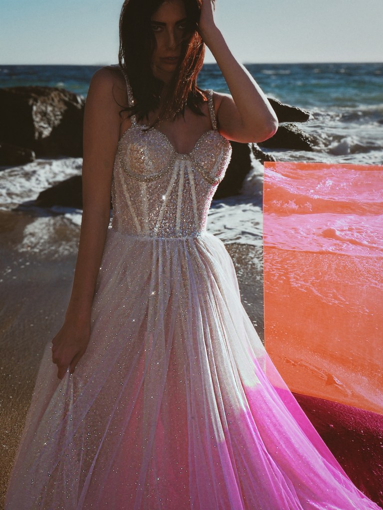 A model wears the Lauren Elaine "Aura" sparkle crystal bustier corset wedding gown.