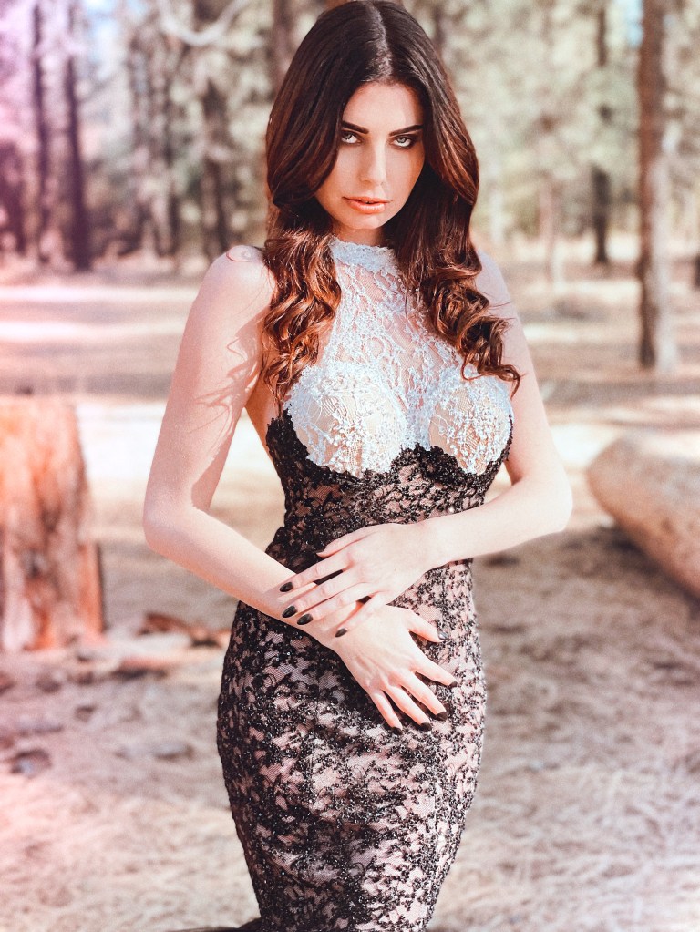 A model wears the Lauren Elaine "raven" black and white tuxedo lace bustier corset mermaid wedding gown.