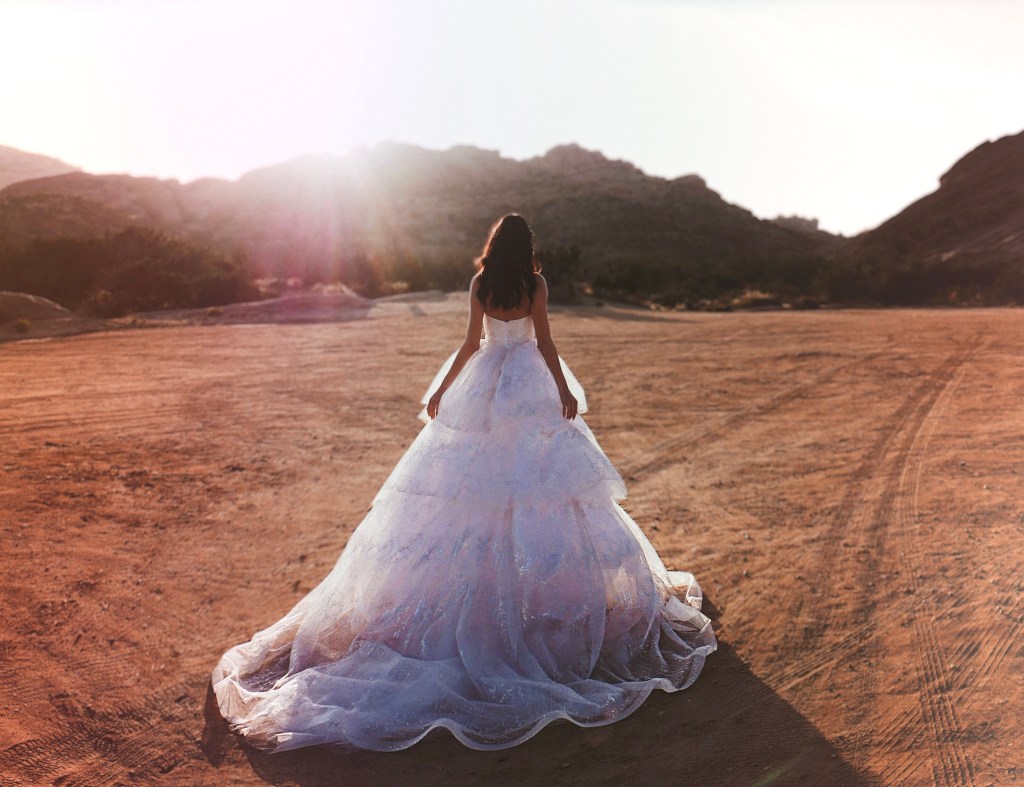 Dramatic tiered wedding dress with cathedral train.