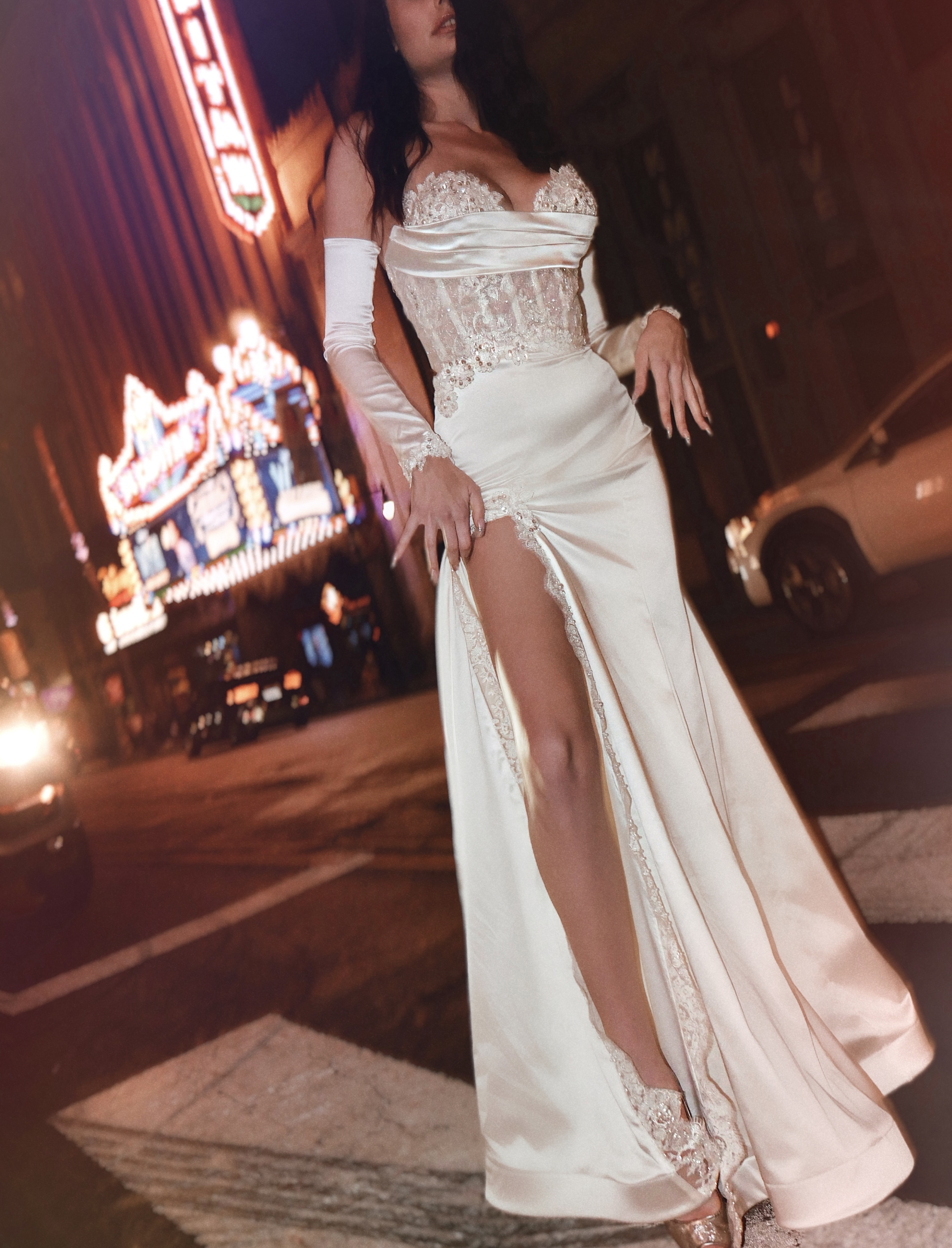 Satin Trumpet Wedding Dress with slit worn by a model on Hollywood blvd.