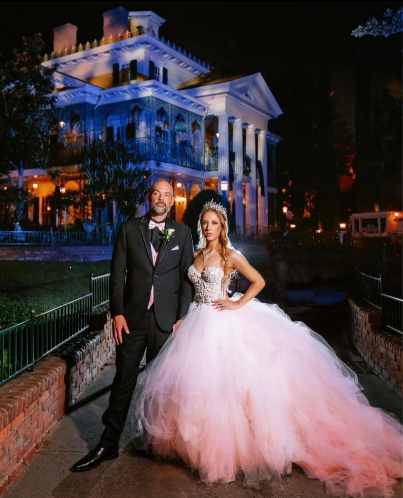 Bride Victoria wears a custom blush pink ombre wedding dress by Lauren Elaine at Disneyland's Haunted Mansion